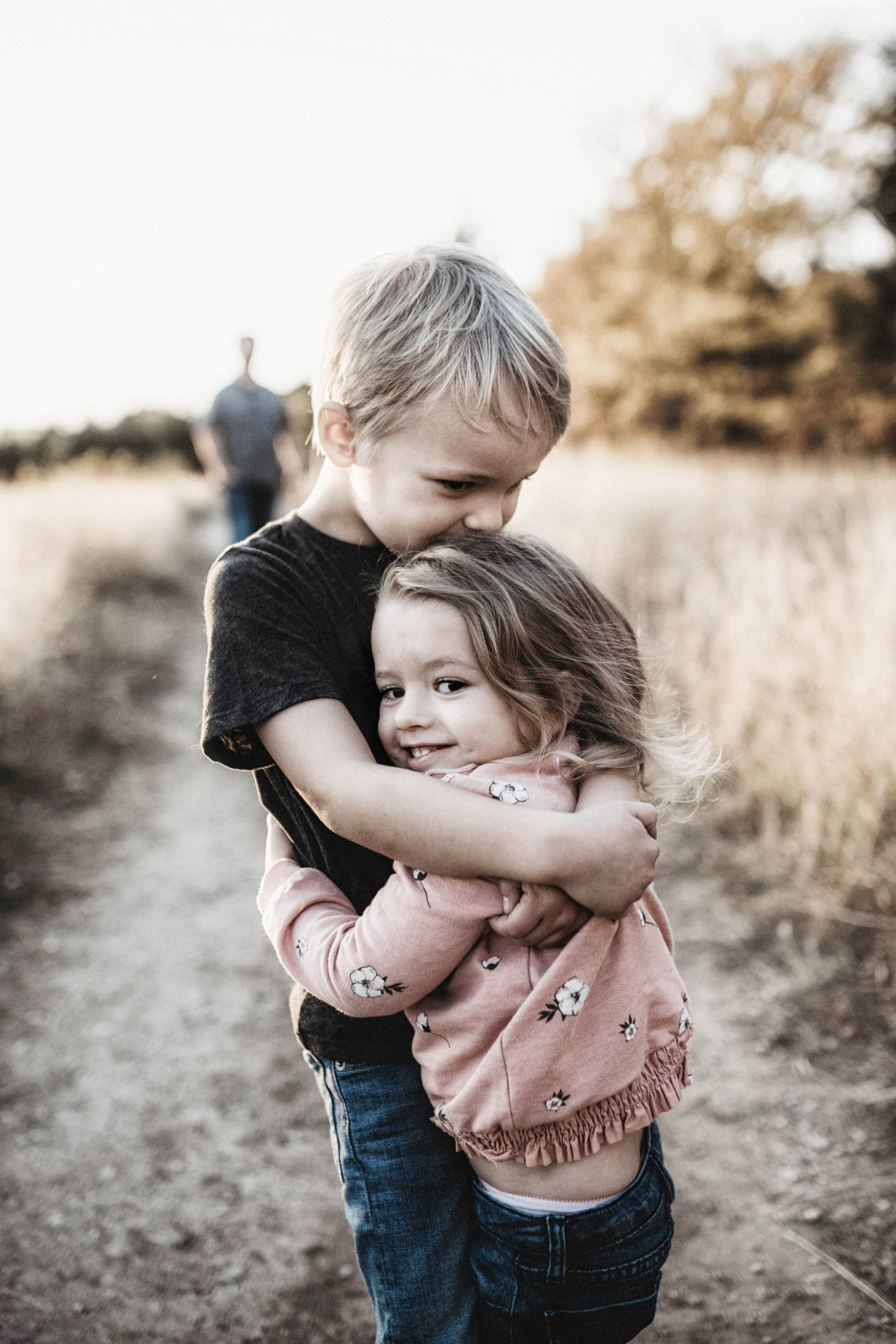Children sharing a hug outdoors